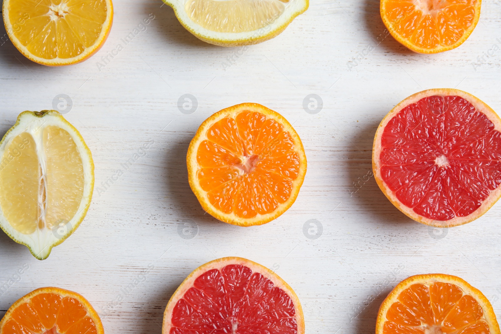 Photo of Tangerines and citrus fruits on wooden background, flat lay