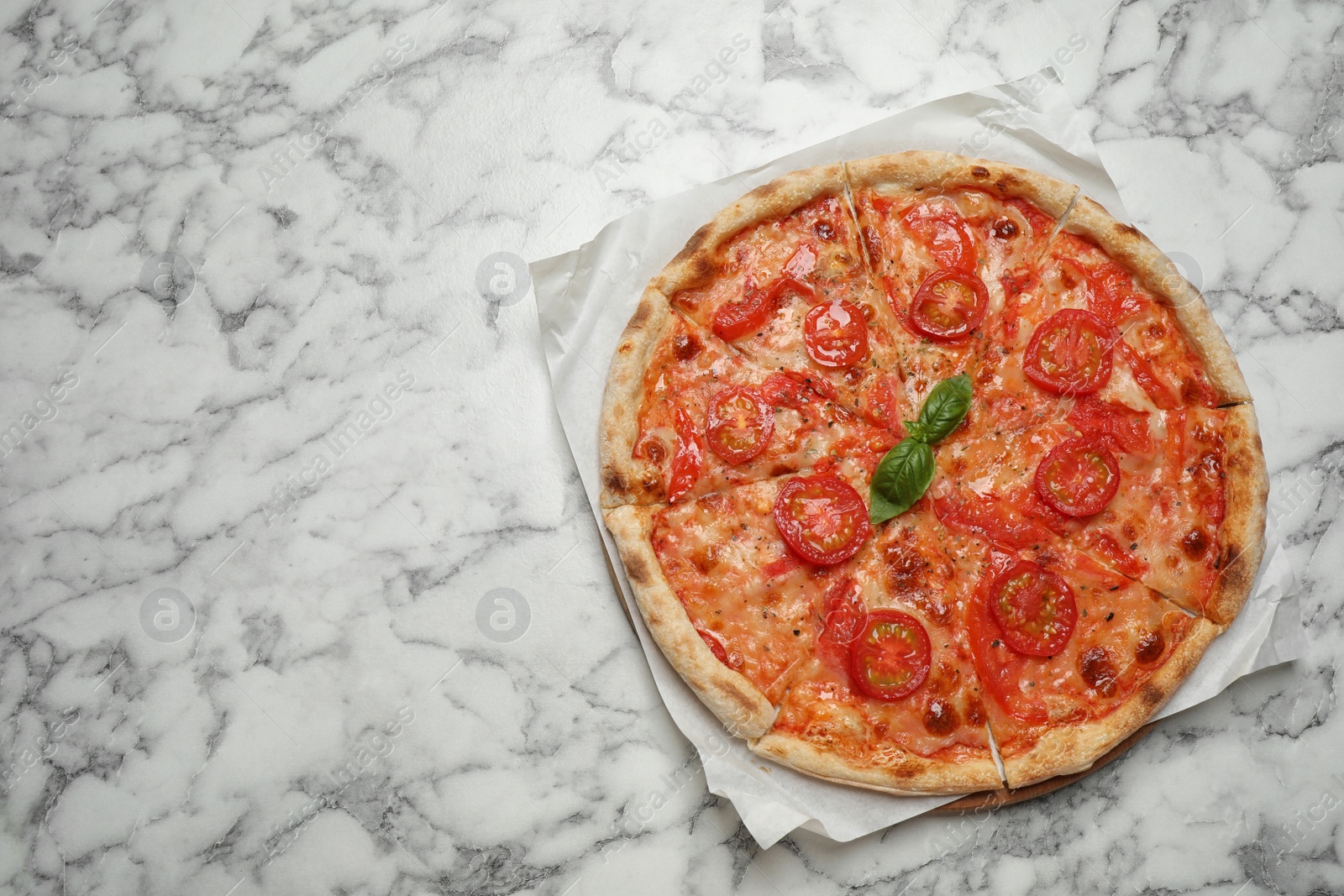 Photo of Delicious pizza Margherita on white marble table, top view. Space for text