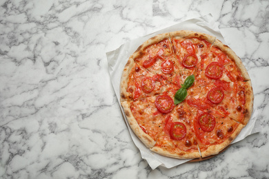 Photo of Delicious pizza Margherita on white marble table, top view. Space for text