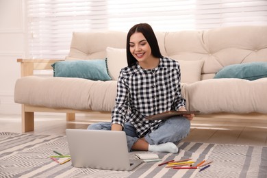 Photo of Happy woman drawing picture at online art lesson indoors. Distant learning