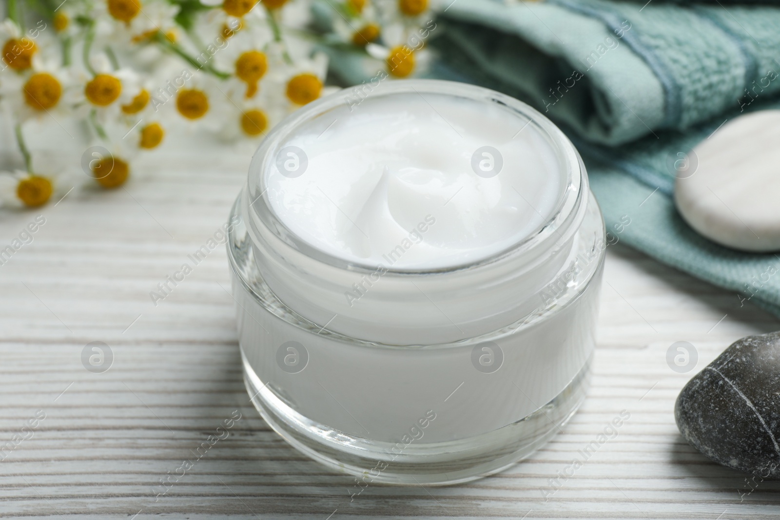 Photo of Jar of organic cream on white wooden table