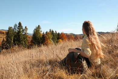 Female traveler viewing peaceful mountain landscape