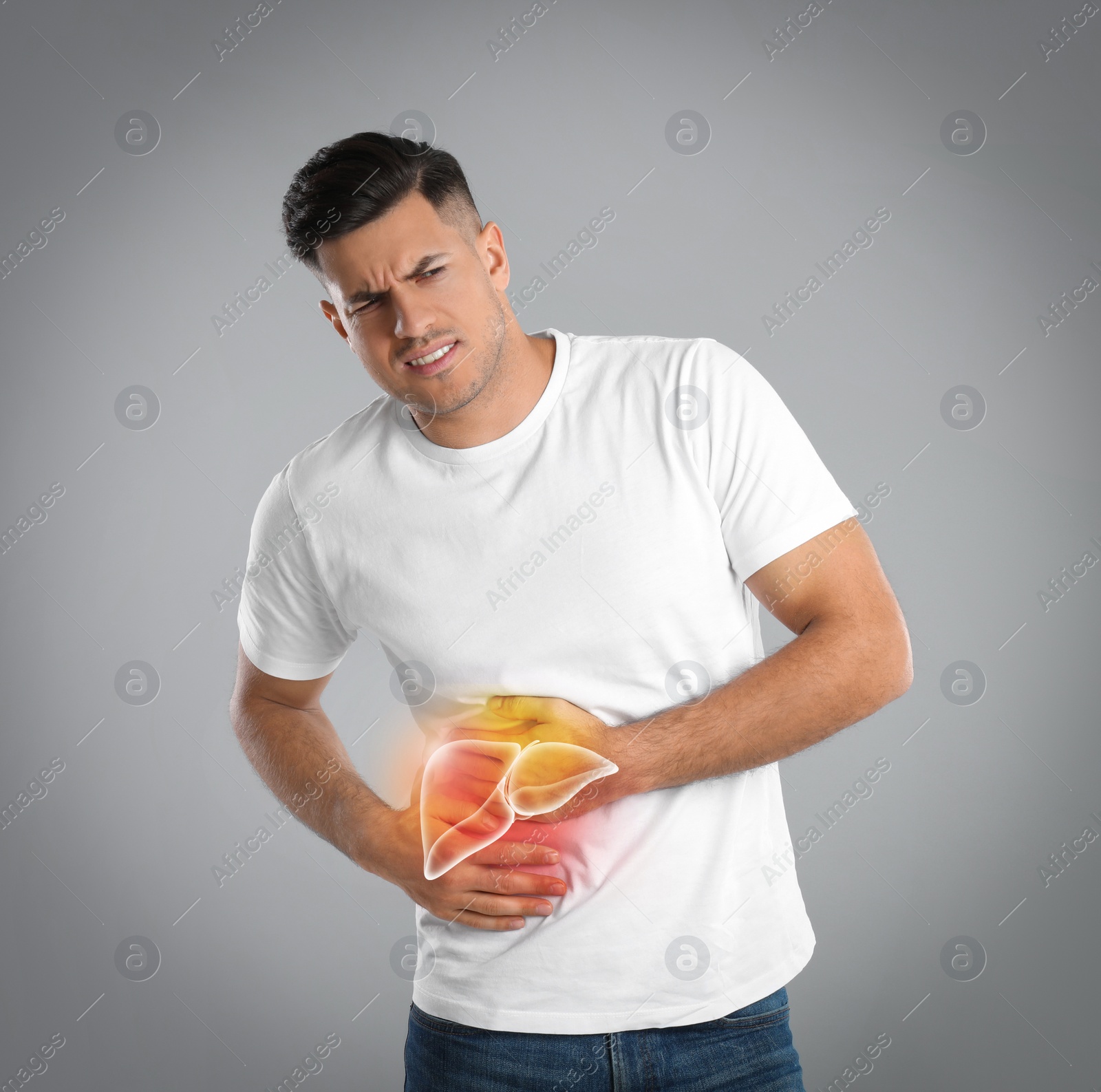 Image of Man suffering from liver pain on grey background