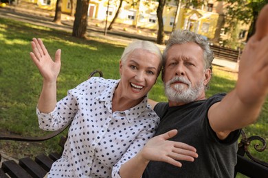 Photo of Lovely mature couple taking selfie in park