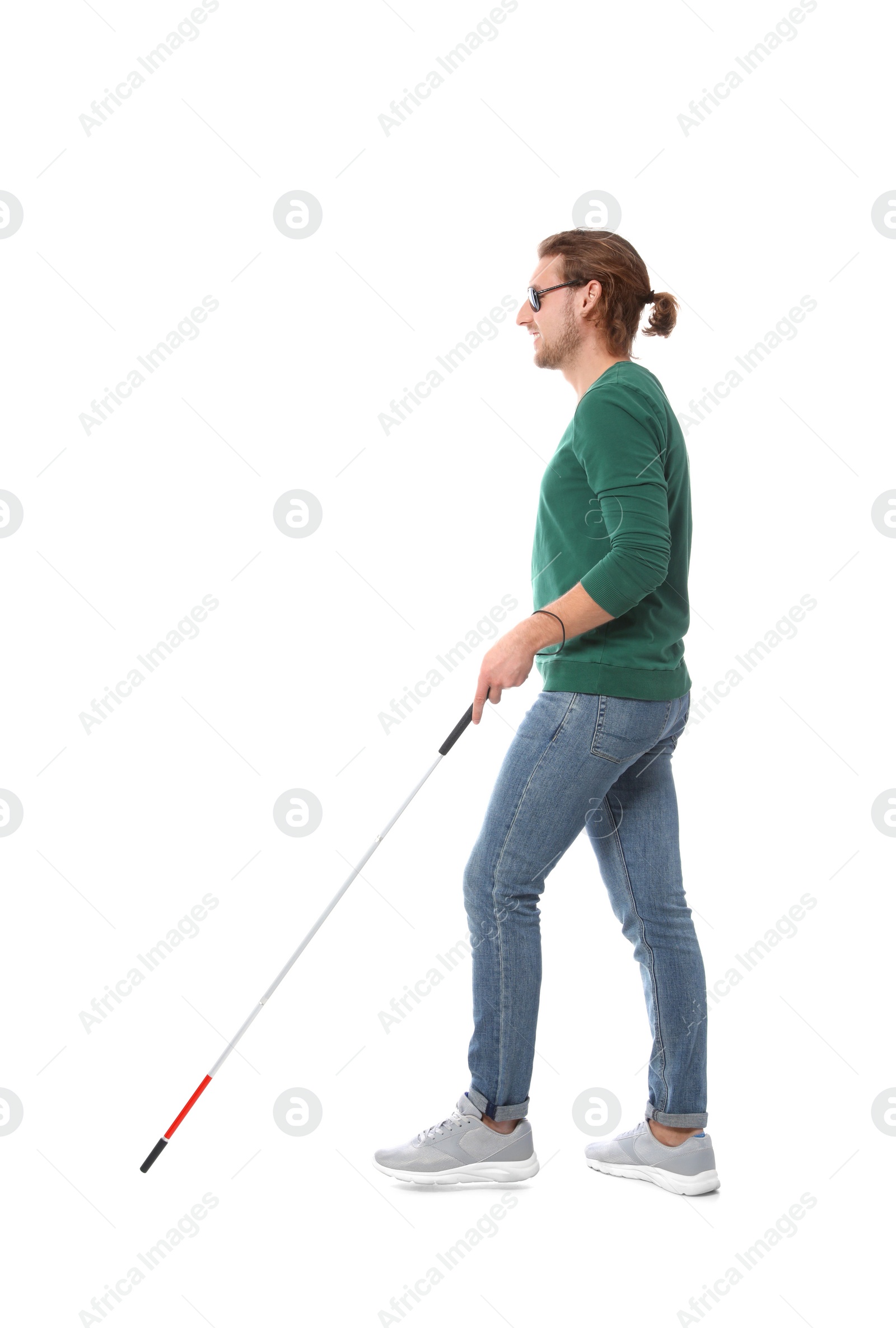 Photo of Blind man in dark glasses with walking cane on white background
