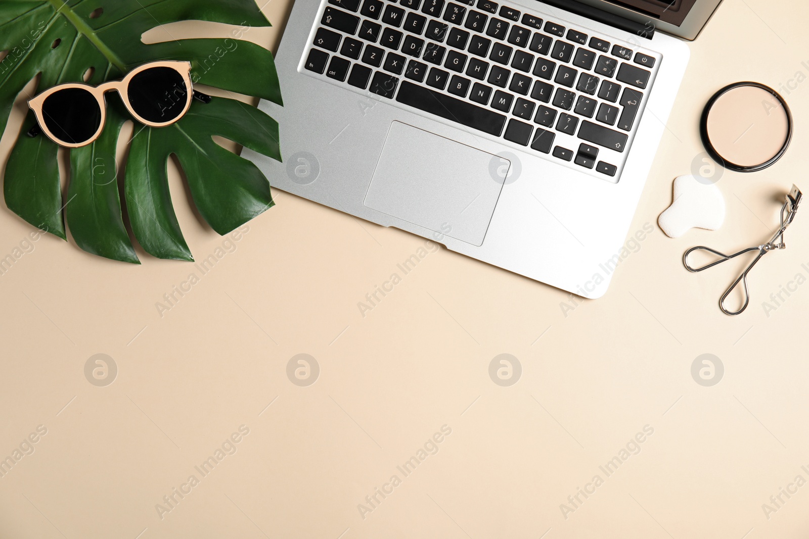 Photo of Flat lay composition with laptop on color background, space for text. Blogger's workplace