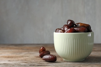 Photo of Bowl with sweet dates on table, space for text. Dried fruit as healthy snack