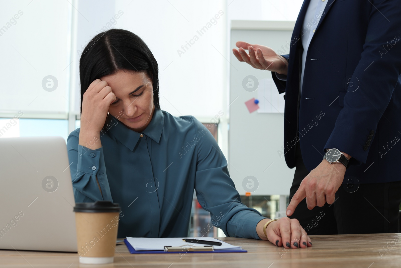 Photo of Businessman scolding employee for being late in office