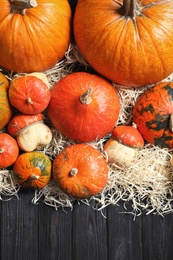 Photo of Flat lay composition with different pumpkins on wooden background. Autumn holidays