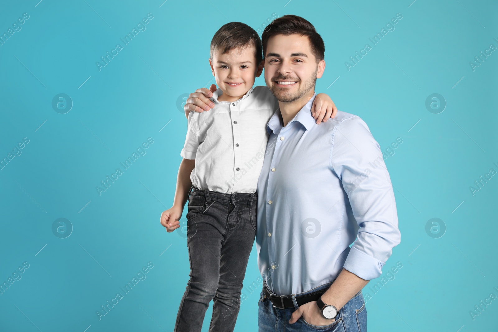 Photo of Portrait of dad and his son on color background