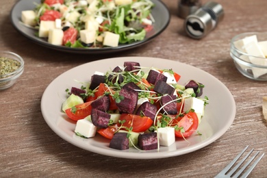 Photo of Delicious carrot salad served on wooden table, closeup