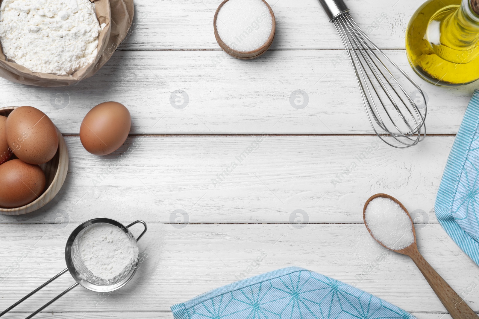 Photo of Flat lay composition with ingredients on white wooden table, space for text. Cooking thin pancakes