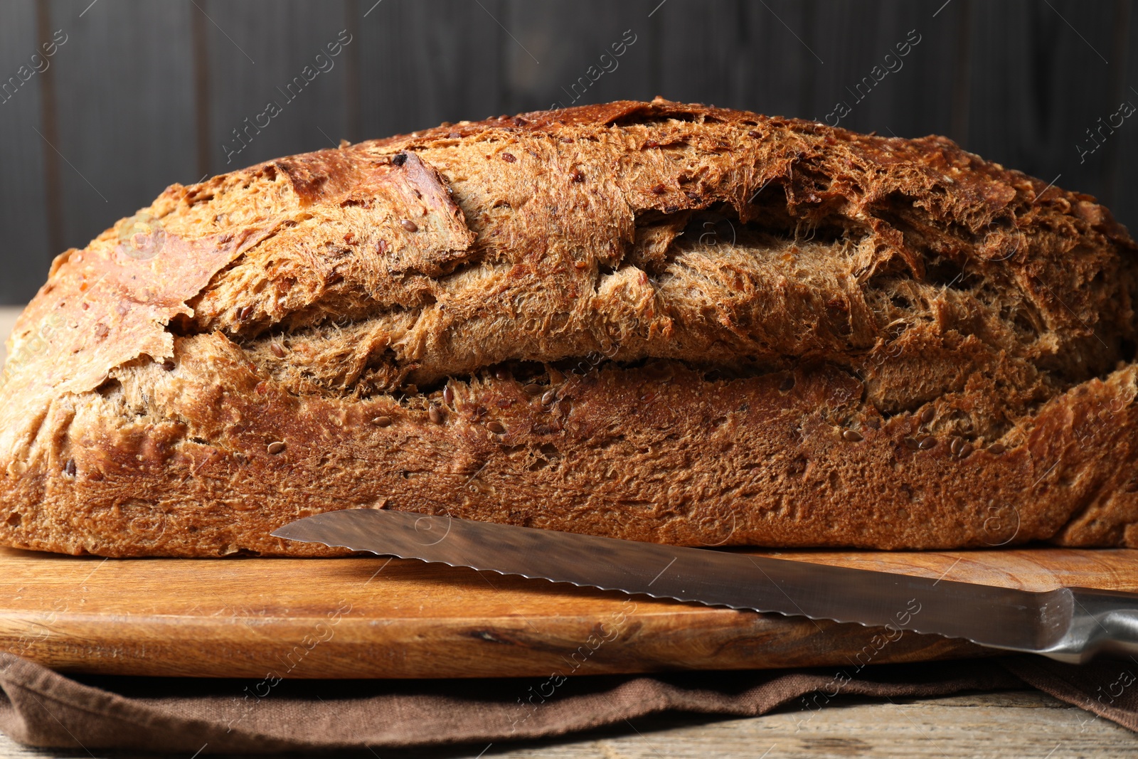 Photo of Freshly baked sourdough bread on wooden table, closeup