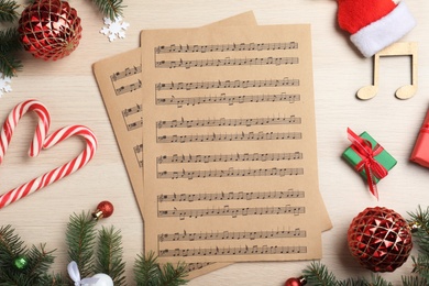 Photo of Flat lay composition with Christmas music sheets on wooden background