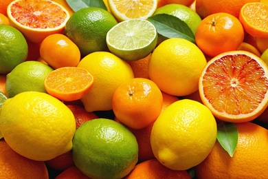 Many different citrus fruits as background, closeup