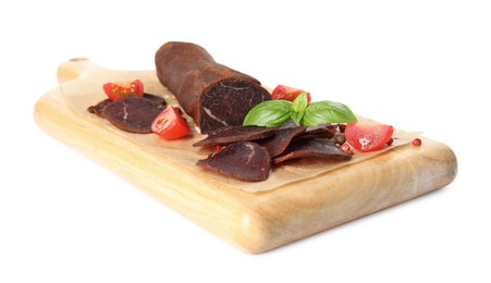 Photo of Delicious dry-cured beef basturma with basil, peppercorns and tomatoes on white background