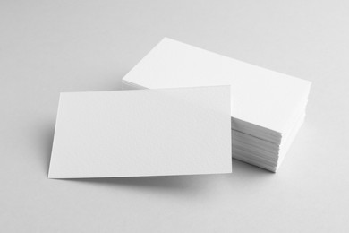 Blank business cards on light grey background. Mockup for design