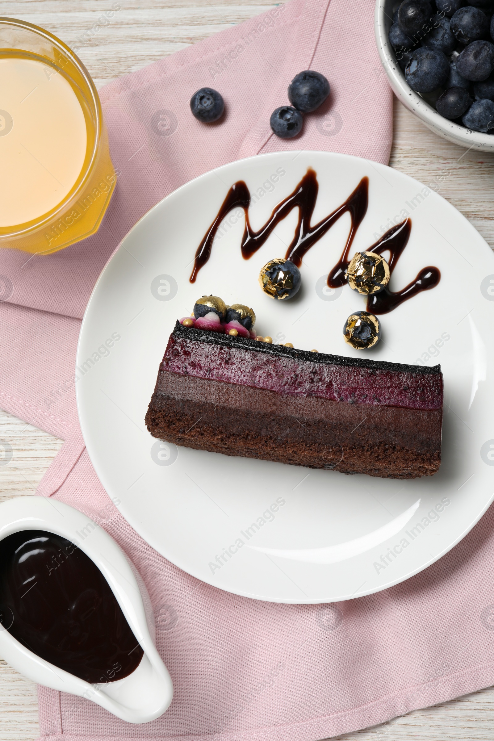 Photo of Delicious cake with blueberry on white wooden table, flat lay