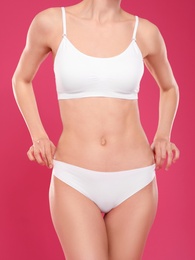 Photo of Slim young woman with smooth gentle skin on color background. Beauty and body care concept