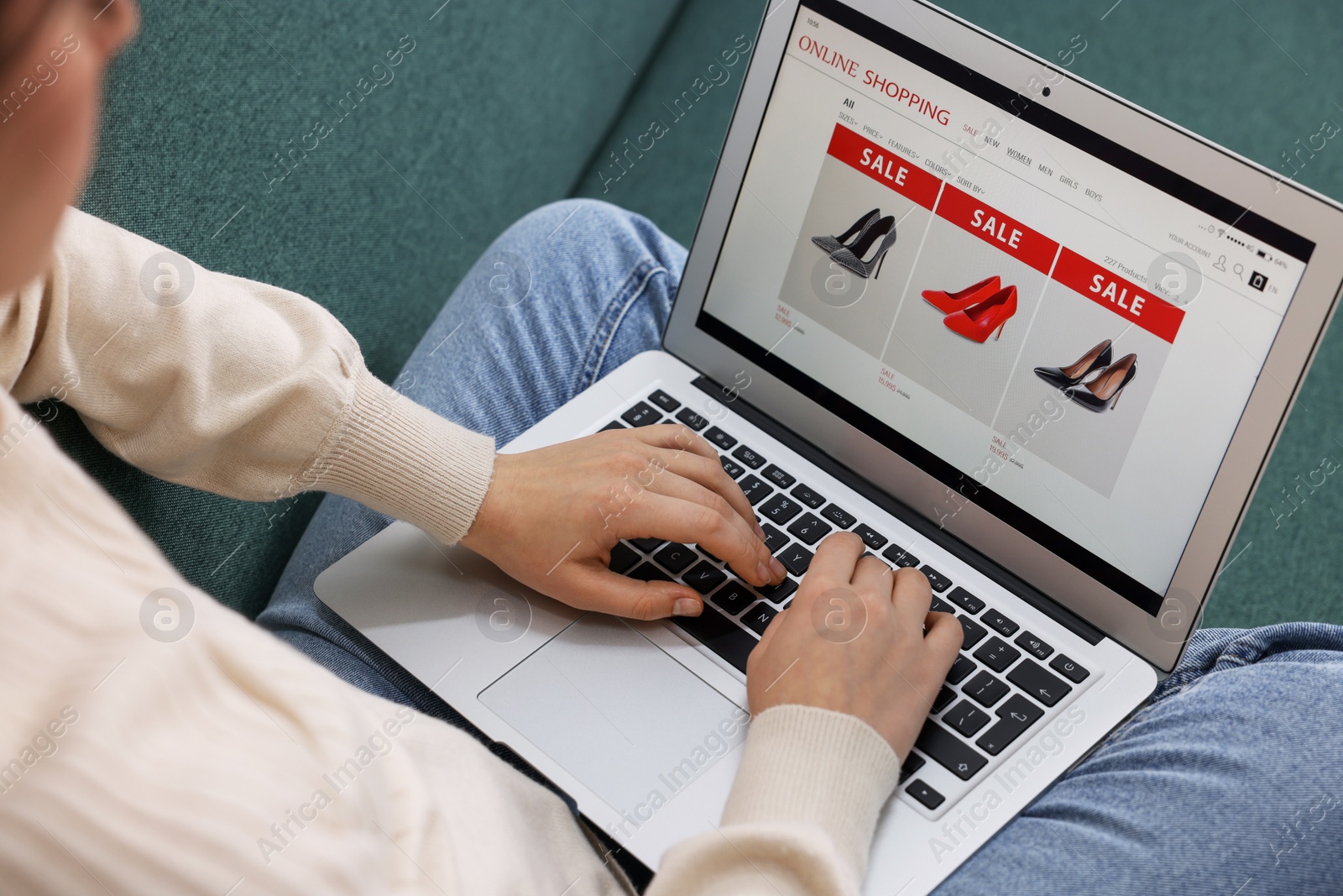 Photo of Woman shopping online during sale on laptop at home, closeup