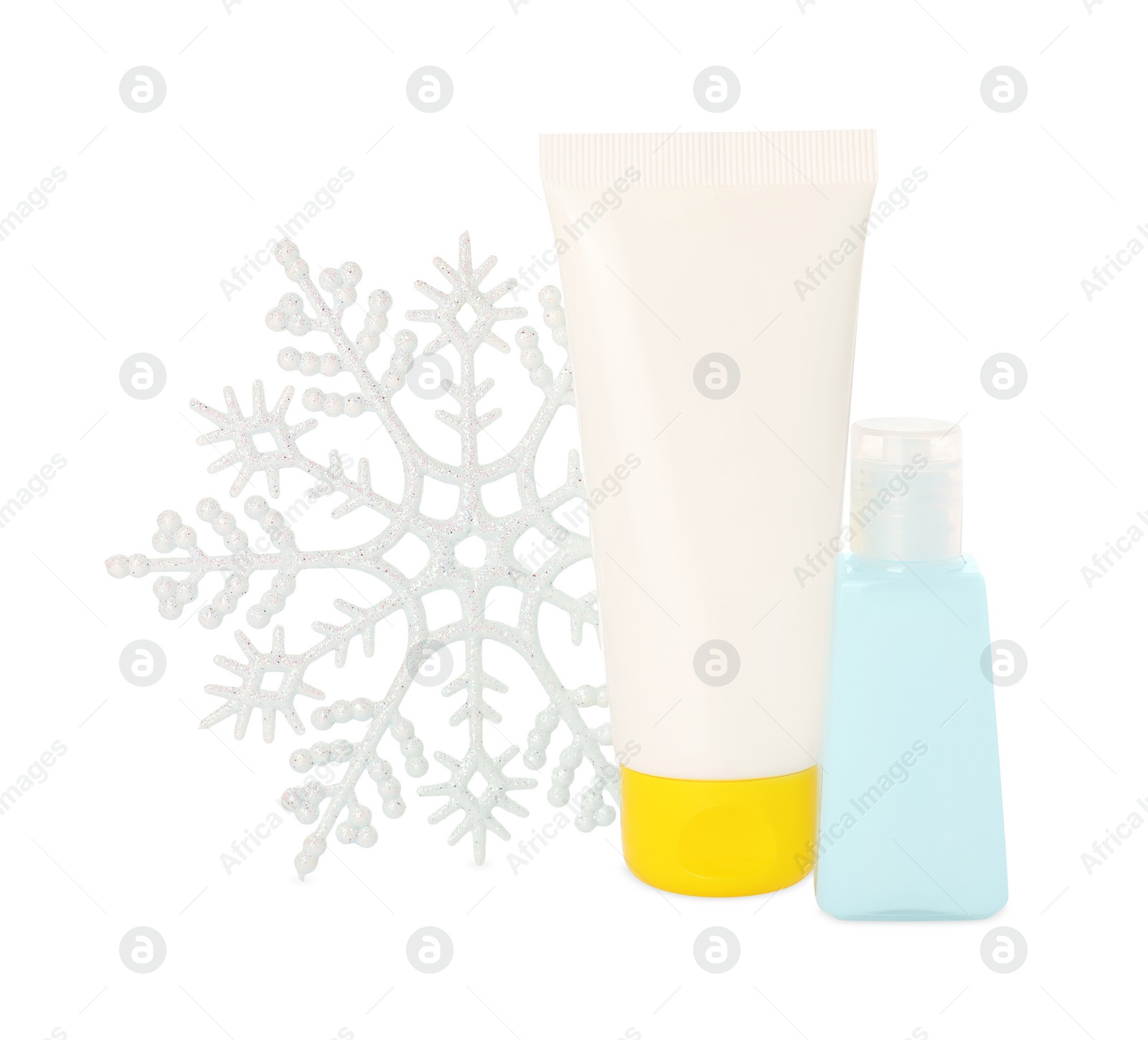 Photo of Set of cosmetic products with hand cream and snowflake isolated on white. Winter skin care