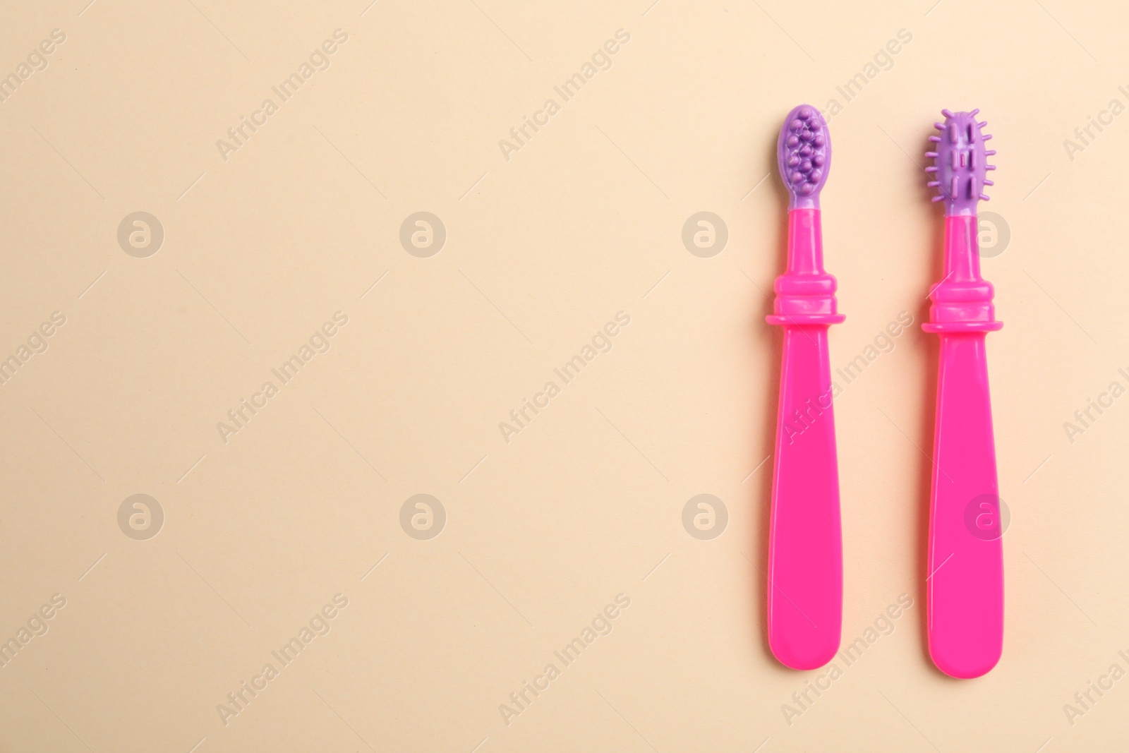 Photo of Manual toothbrushes for children on color background, top view with space for text