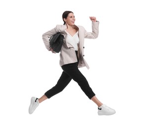 Photo of Beautiful businesswoman in suit with briefcase jumping on white background