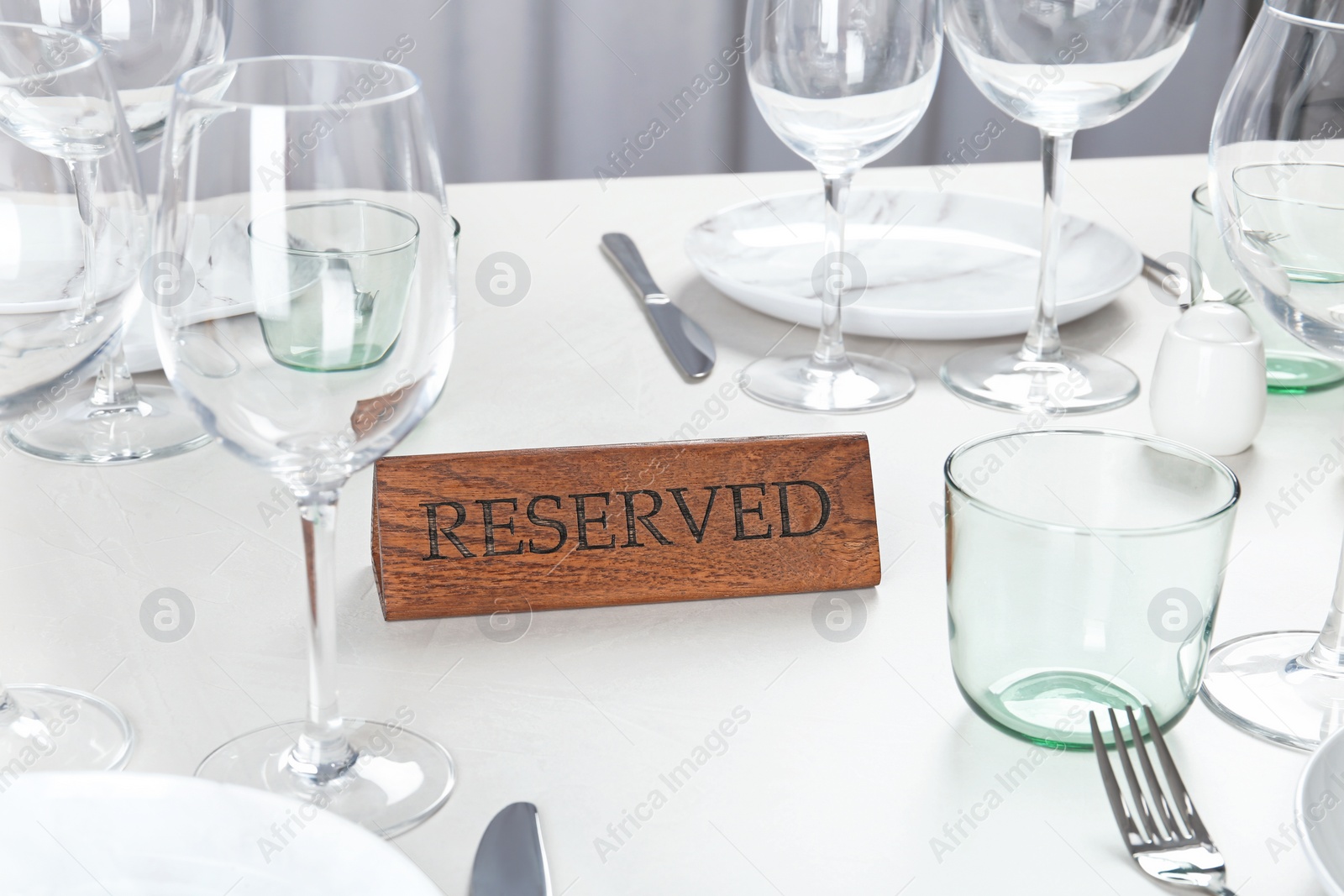 Photo of Table setting with RESERVED sign in restaurant