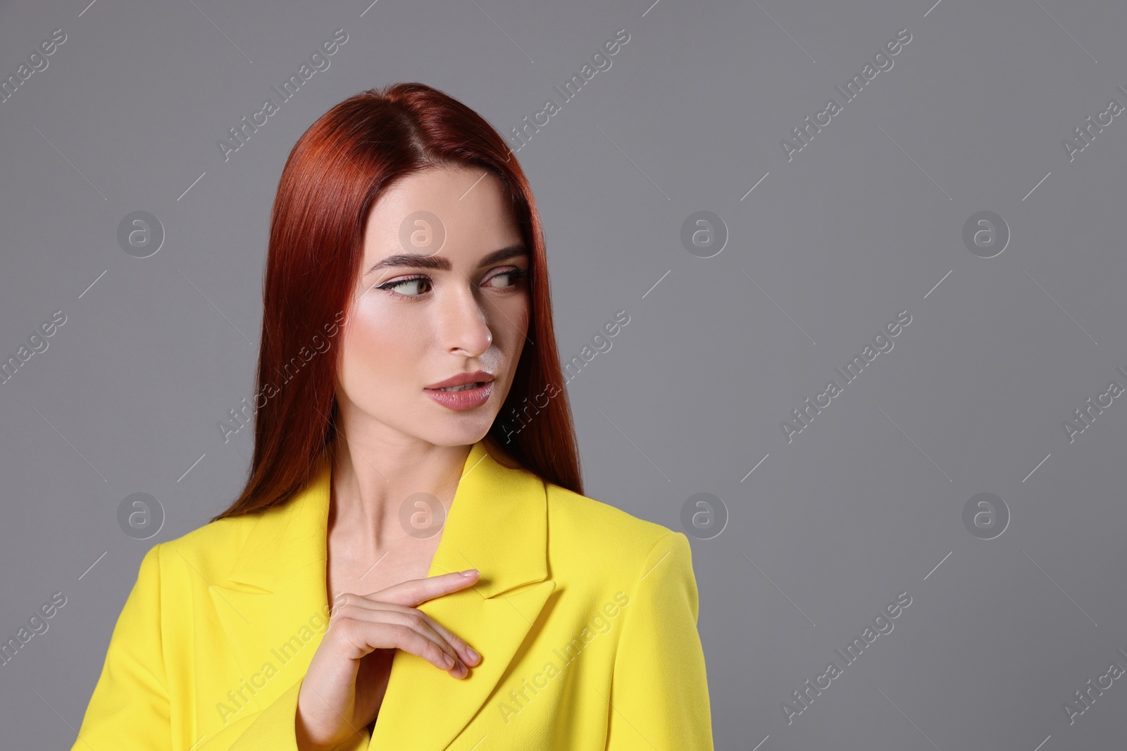 Photo of Beautiful woman with red dyed hair on light gray background, space for text