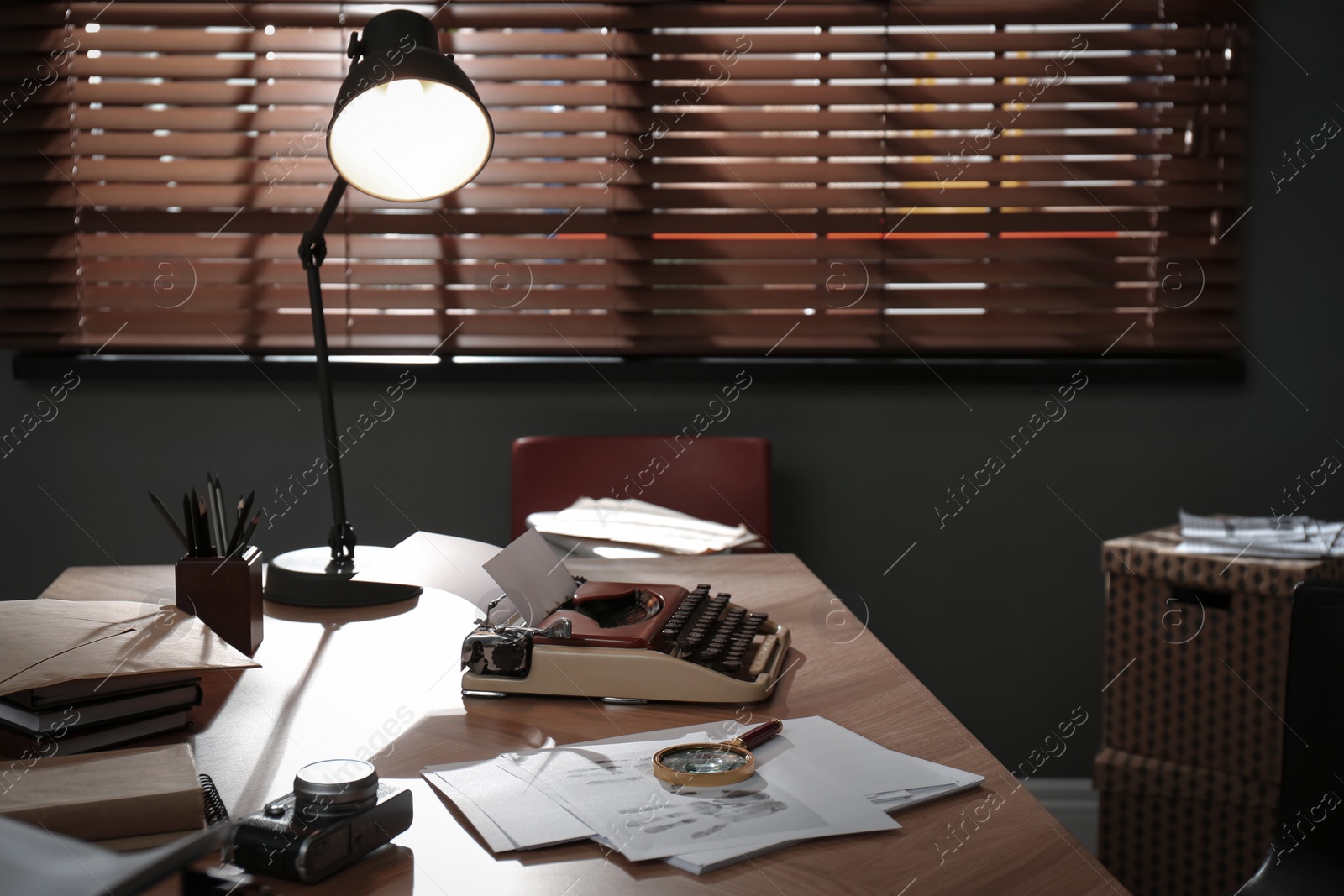 Photo of Typewriter, fingerprints and papers on desk in office. Detective's workplace