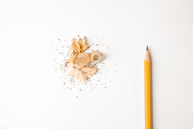 Photo of Pencil and shavings on white background, top view