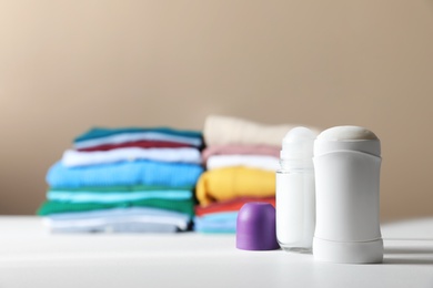 Photo of Different deodorants on white table. Space for text