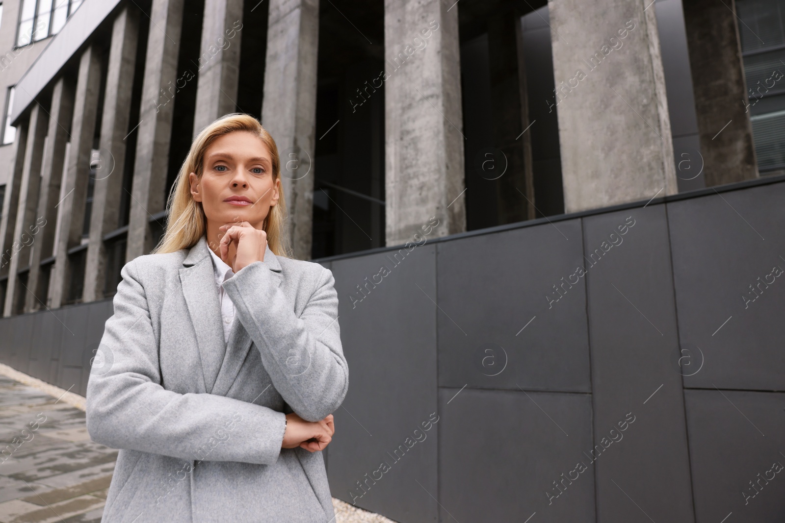 Photo of Portrait of thoughtful woman outdoors, space for text. Lawyer, businesswoman, accountant or manager