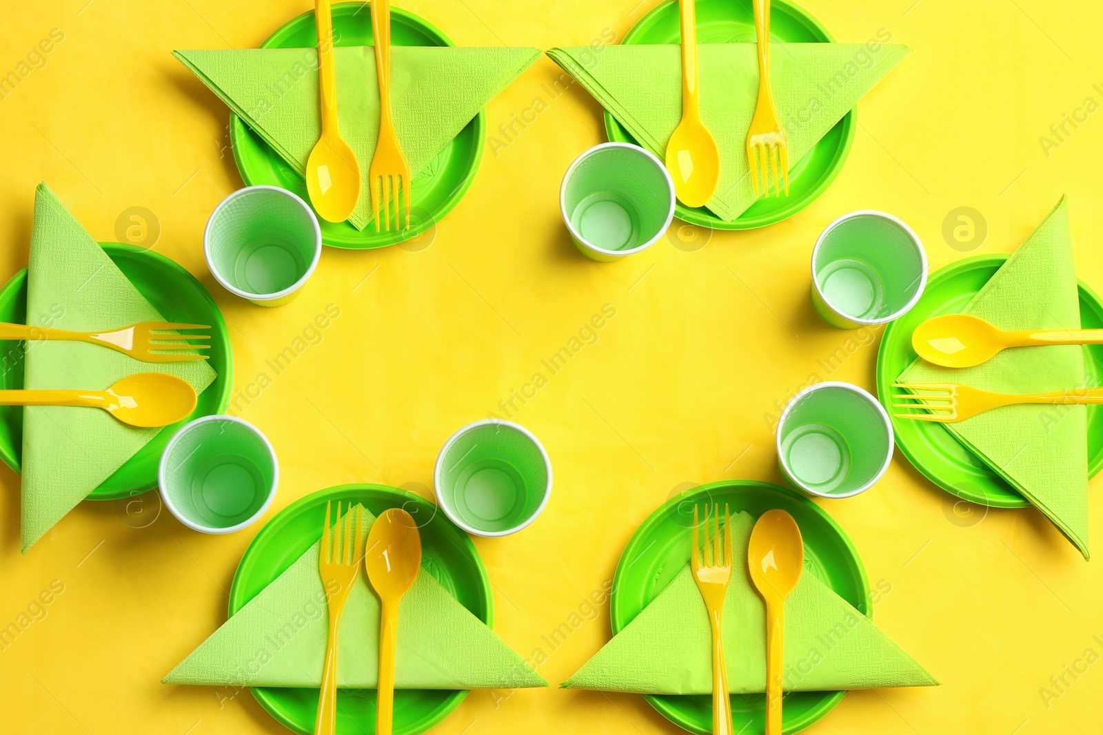 Photo of Table setting with plastic dishware on color background, top view