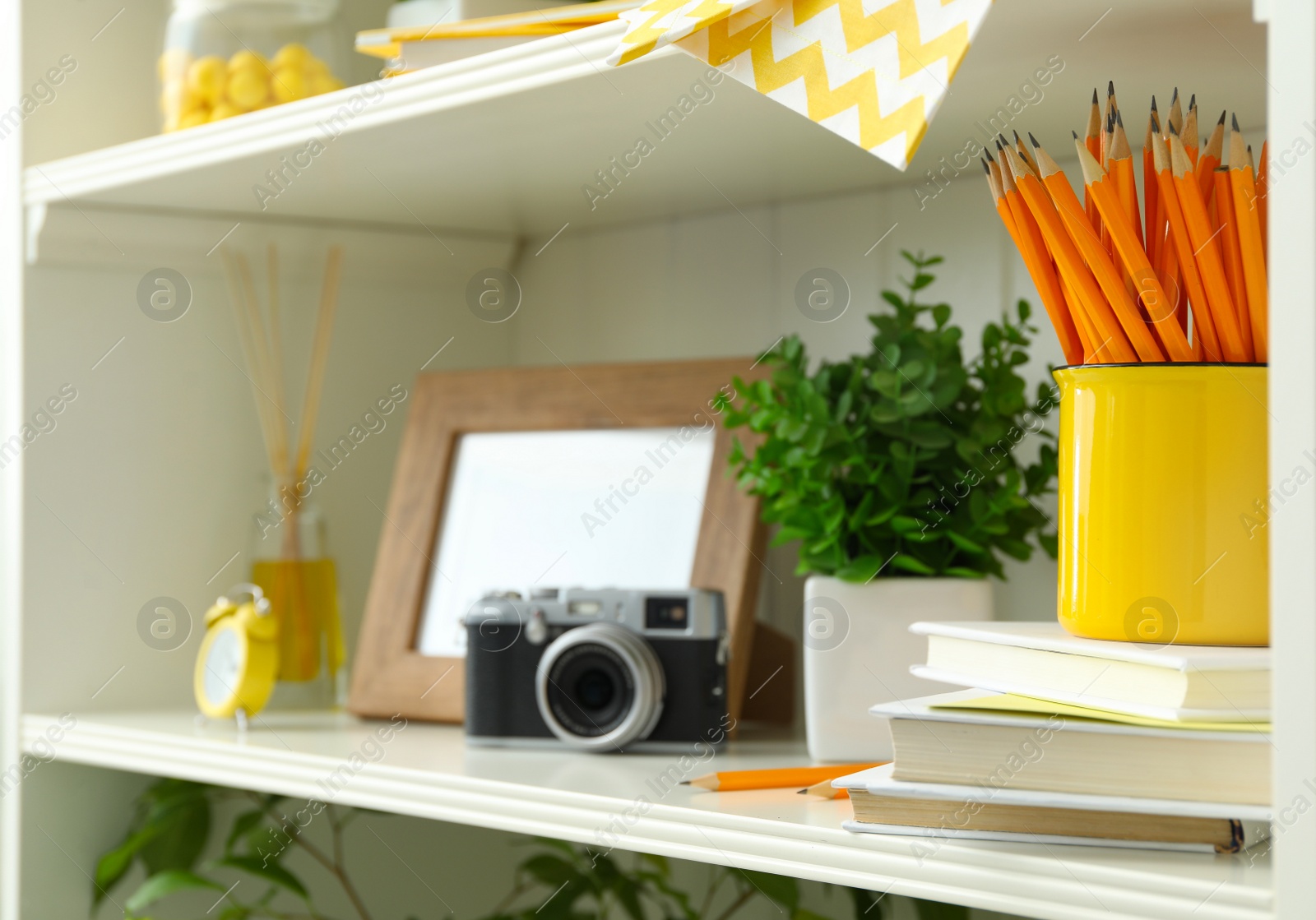 Photo of White shelving unit with retro camera and photo frames