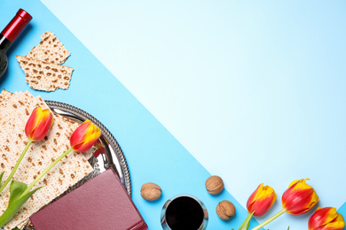 Photo of Flat lay composition with symbolic Pesach (Passover Seder) items on color background, space for text