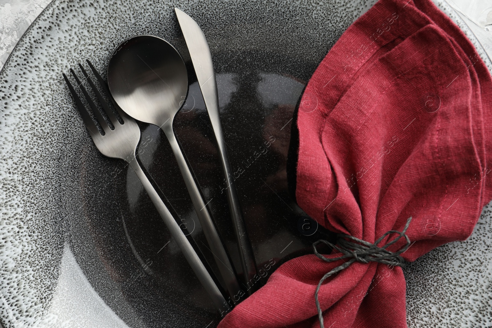 Photo of Stylish setting with cutlery, napkin and plate on table, top view