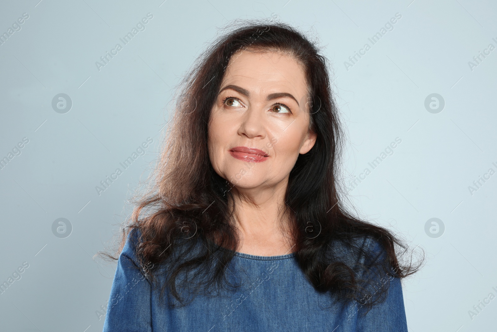 Photo of Portrait of mature woman with beautiful face on grey background