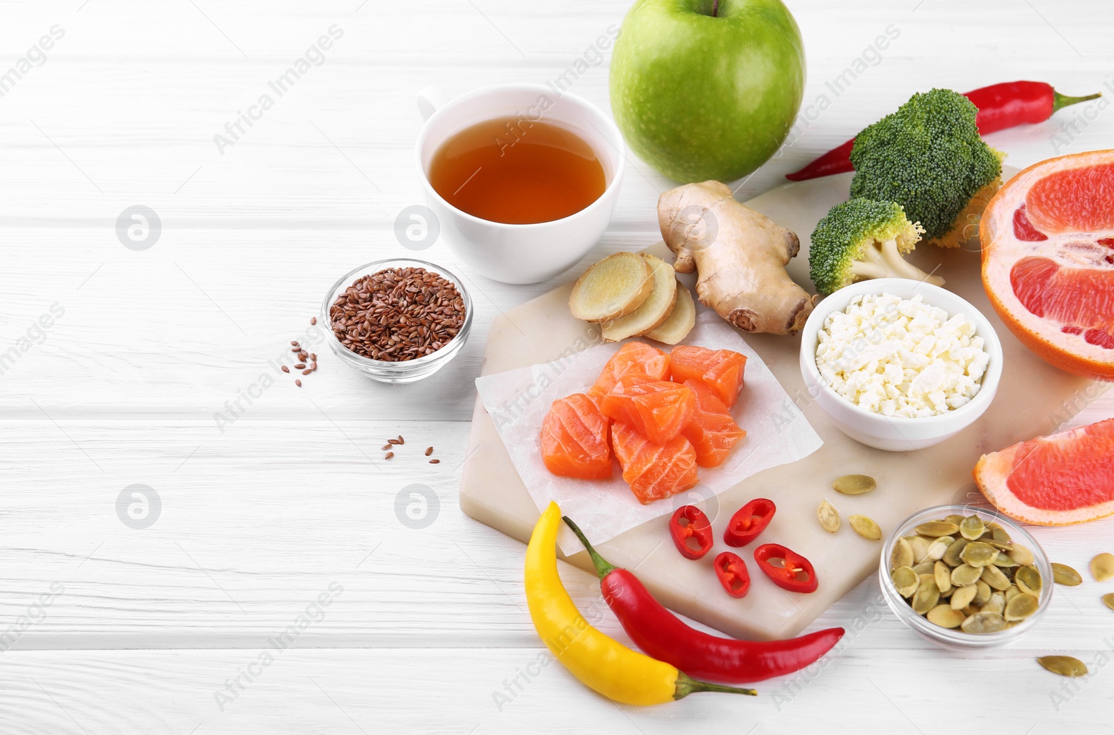 Photo of Metabolism. Different food products on white wooden table, space for text