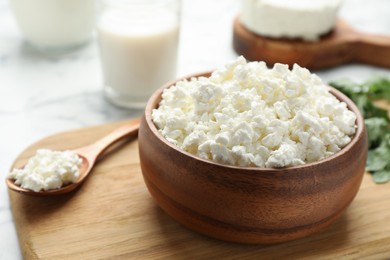 Photo of Delicious fresh cottage cheese in bowl on table, closeup