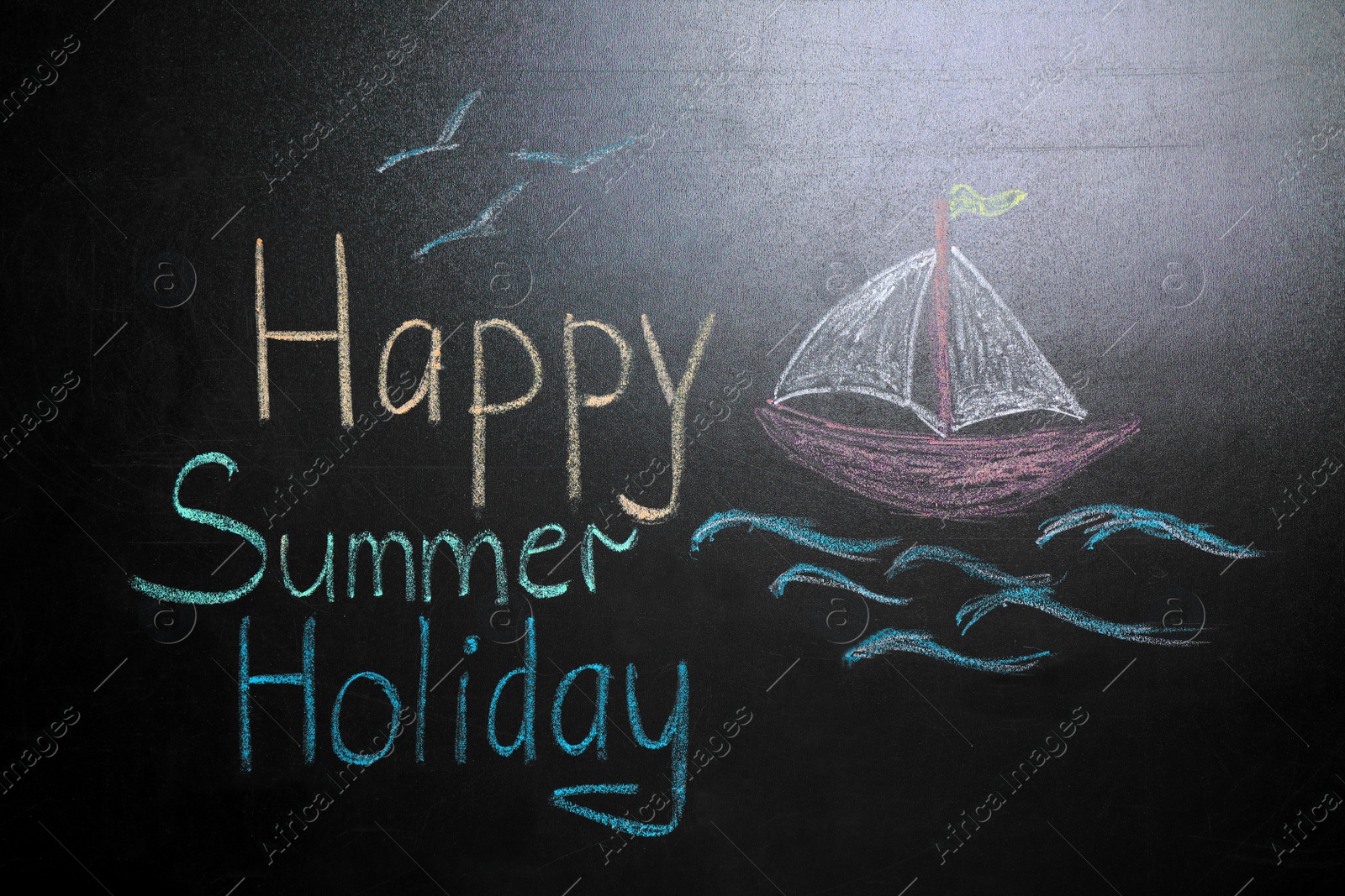 Photo of Inscription Happy Summer Holiday and drawing of boat on blackboard. School break