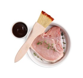 Photo of Raw meat, thyme and brush with marinade isolated on white, top view
