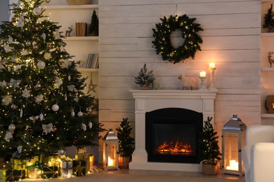 Stylish living room interior with decorated Christmas tree and comfortable sofa