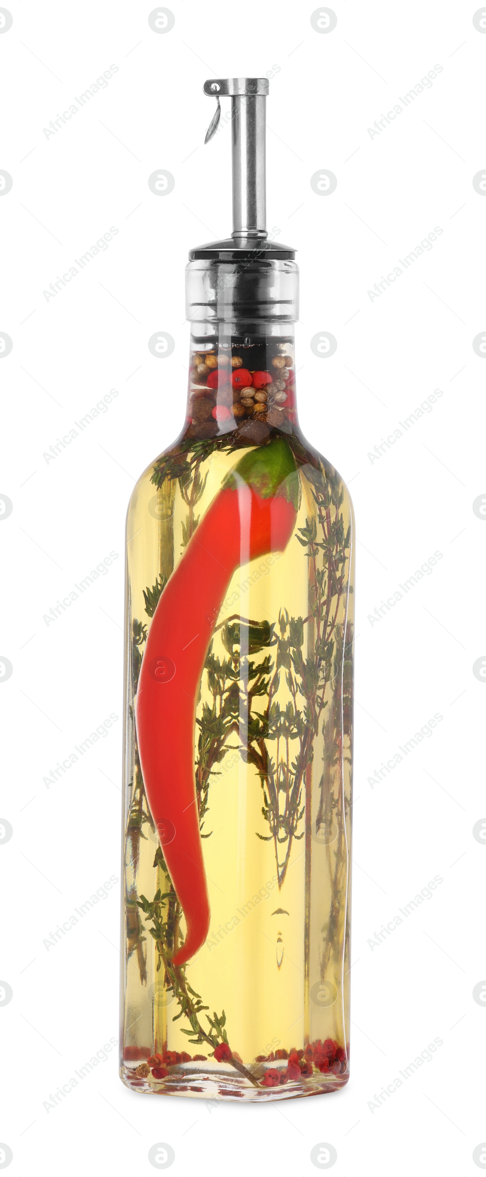 Photo of Glass bottle of cooking oil with spices and herbs isolated on white