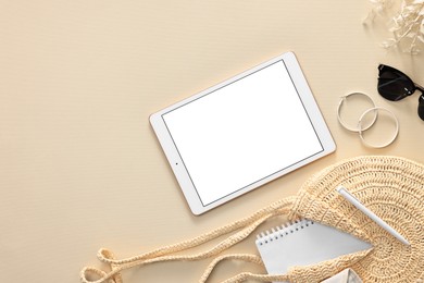 Photo of Flat lay composition with modern tablet on beige background. Space for text