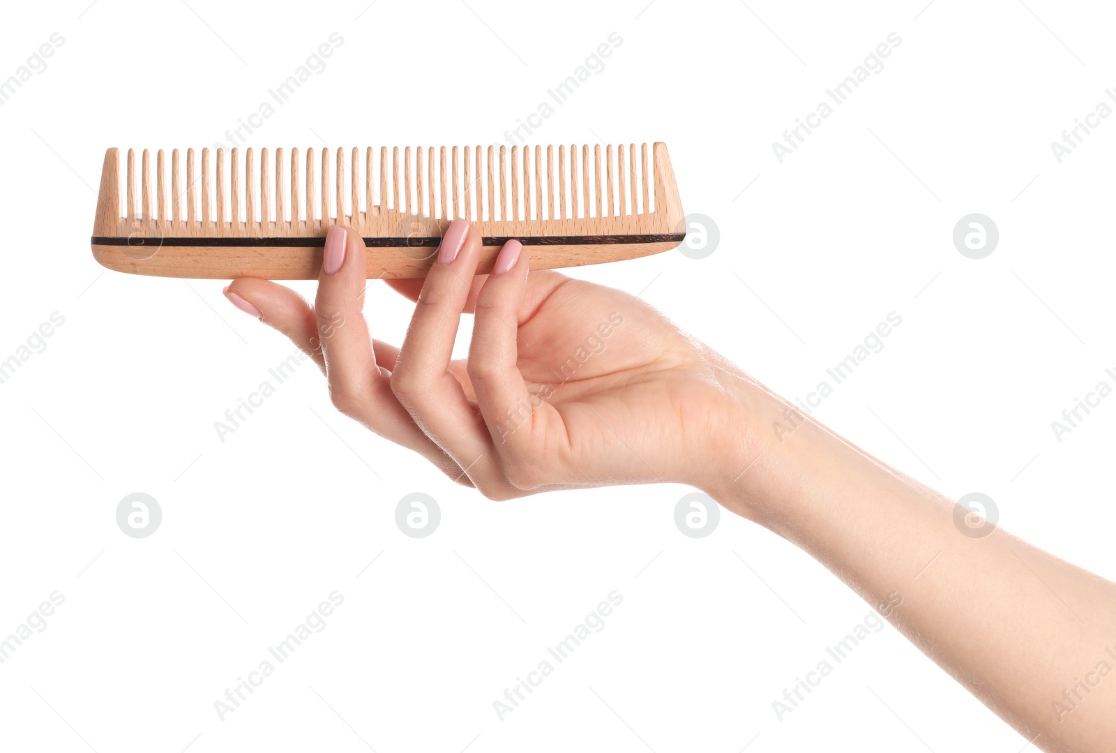 Photo of Woman holding wooden hair comb against white background, closeup