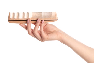 Photo of Woman holding wooden hair comb against white background, closeup