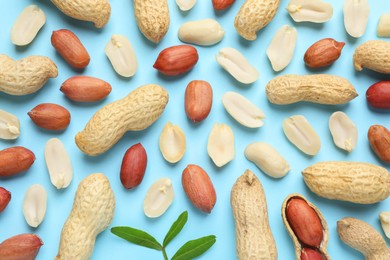 Fresh peanuts on light blue background, flat lay