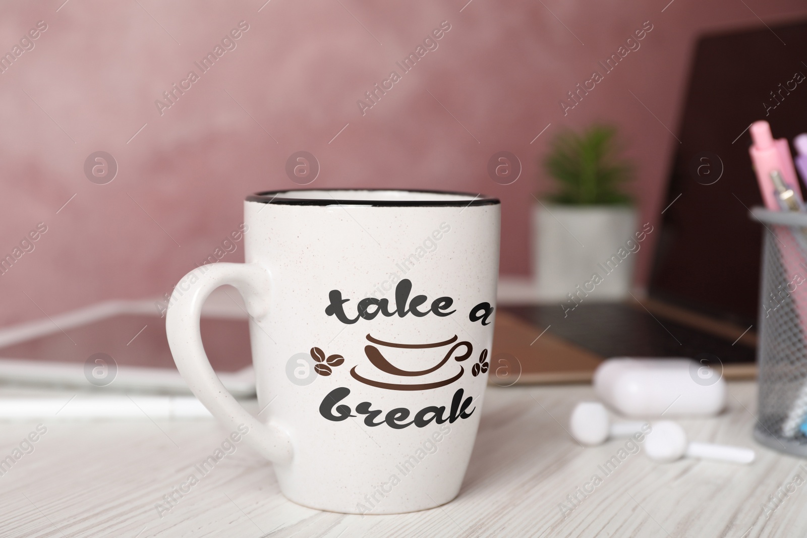 Image of Cup of coffee with inscription Take a Break on white wooden table in office