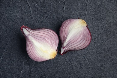 Ripe cut red onion on dark background, top view